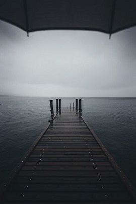 Rainy day looking out to sea. Photo by Alessio Lin on Unsplash website.