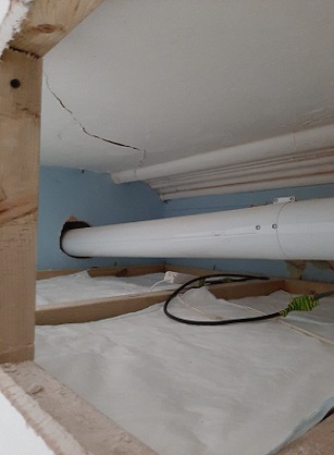 FloodSax beneath a major pipe leading from the boiler at Christine Butler’s flat
