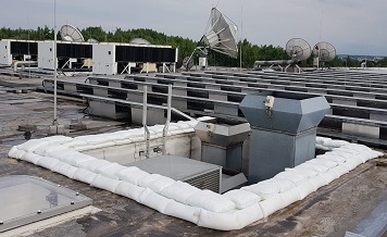 FloodSax alternative sandbags were placed around a faulty air conditioning unit to prevent water from damaging this commercial building